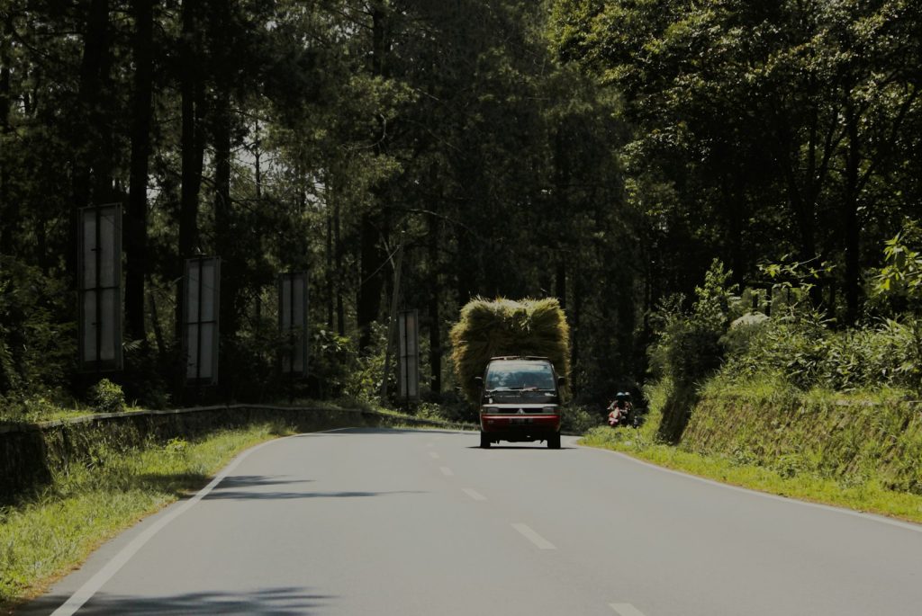 red suv on road during daytime